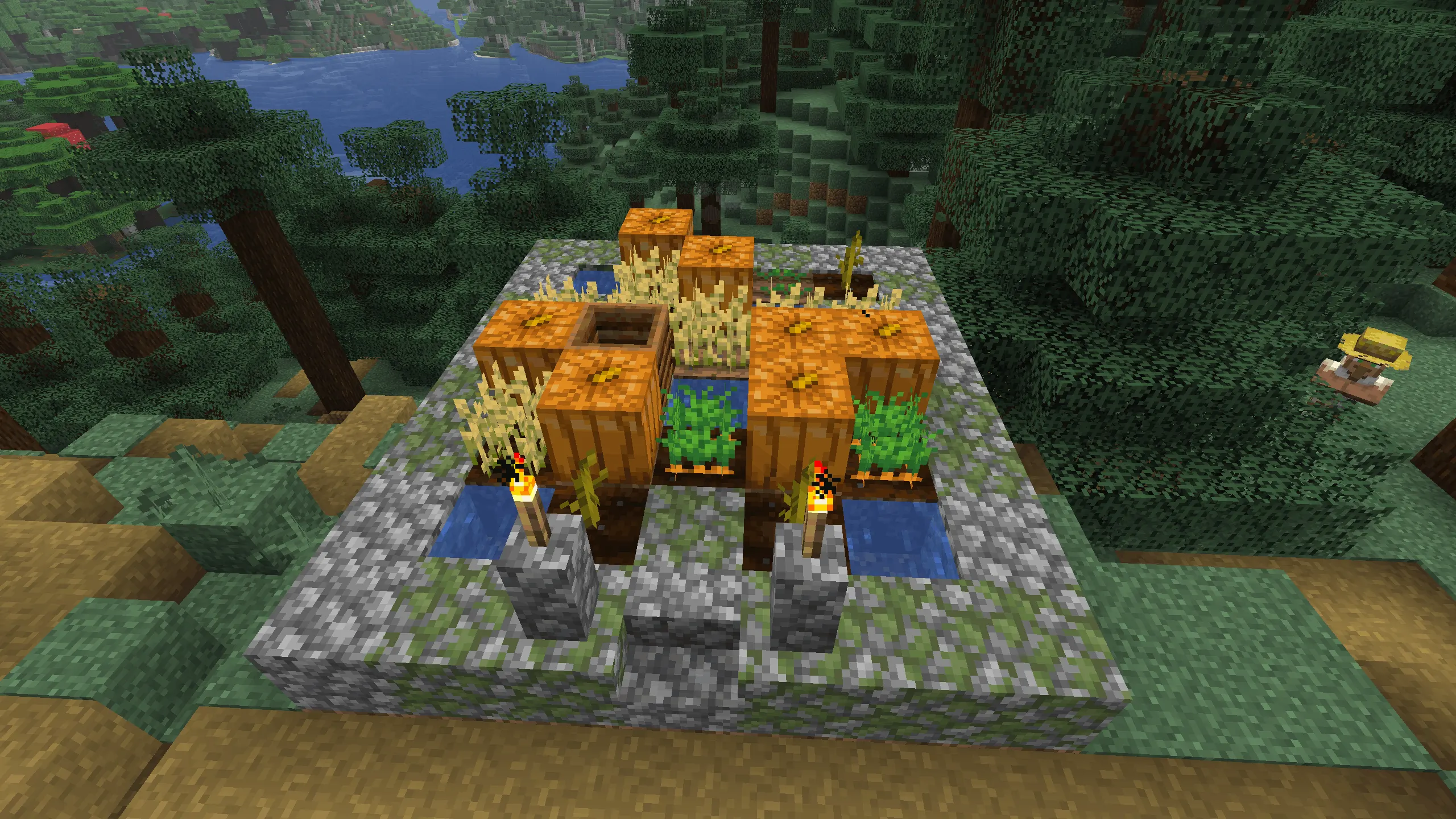 A close-up Minecraft screenshot of a small, raised farm plot in a Taiga village. The garden is bordered by mossy cobblestone and contains pumpkins, wheat, and carrots surrounding a central composter and water source. Two lit torches on stone pillars illuminate the front, with a dense spruce forest and a river visible in the background.