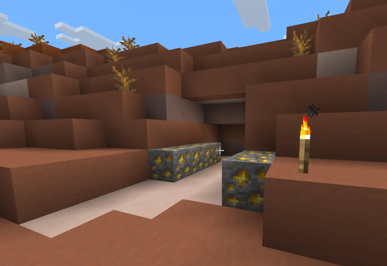 Minecraft badlands biome mesa with terracotta cliffs and gold ore