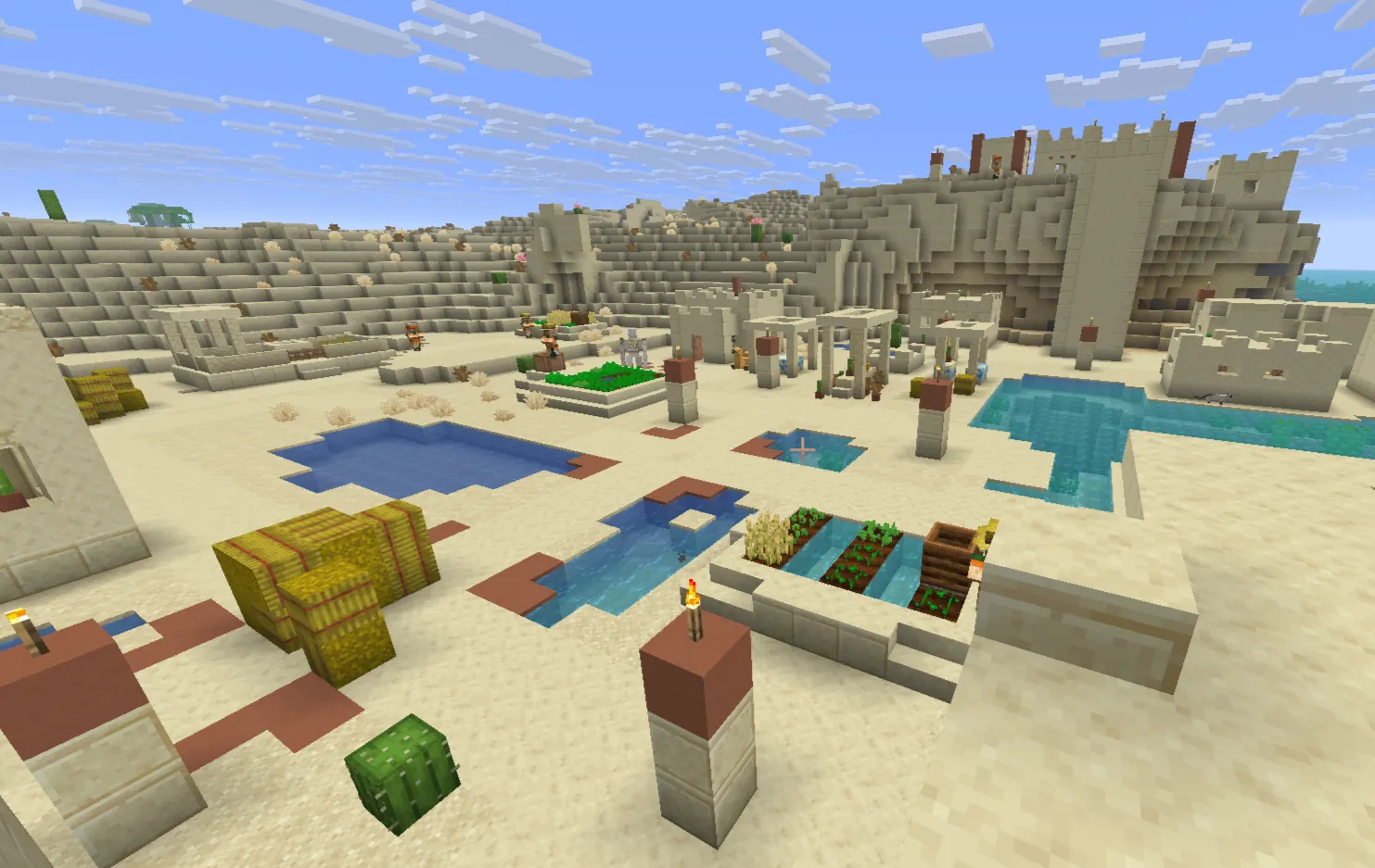 Minecraft desert village with farms, houses, and villagers in a sandy biome