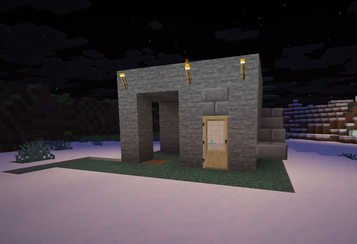 Simple snow block shelter in Minecraft snowy tundra with torch light for first night survival