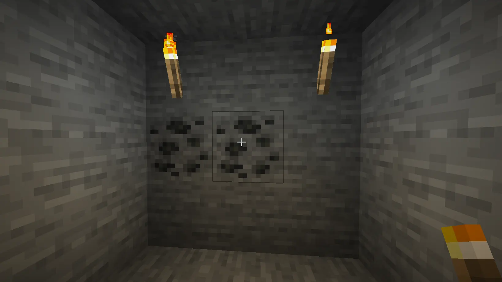 Coal ore blocks in Minecraft cave used for crafting torches