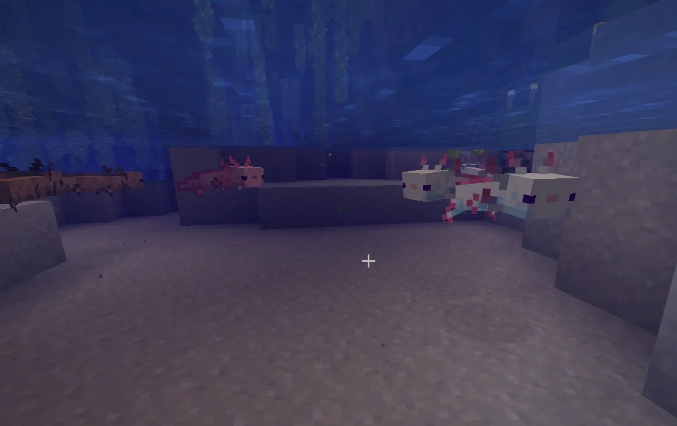 Axolotls are swimming in a lush cave water pool in Minecraft