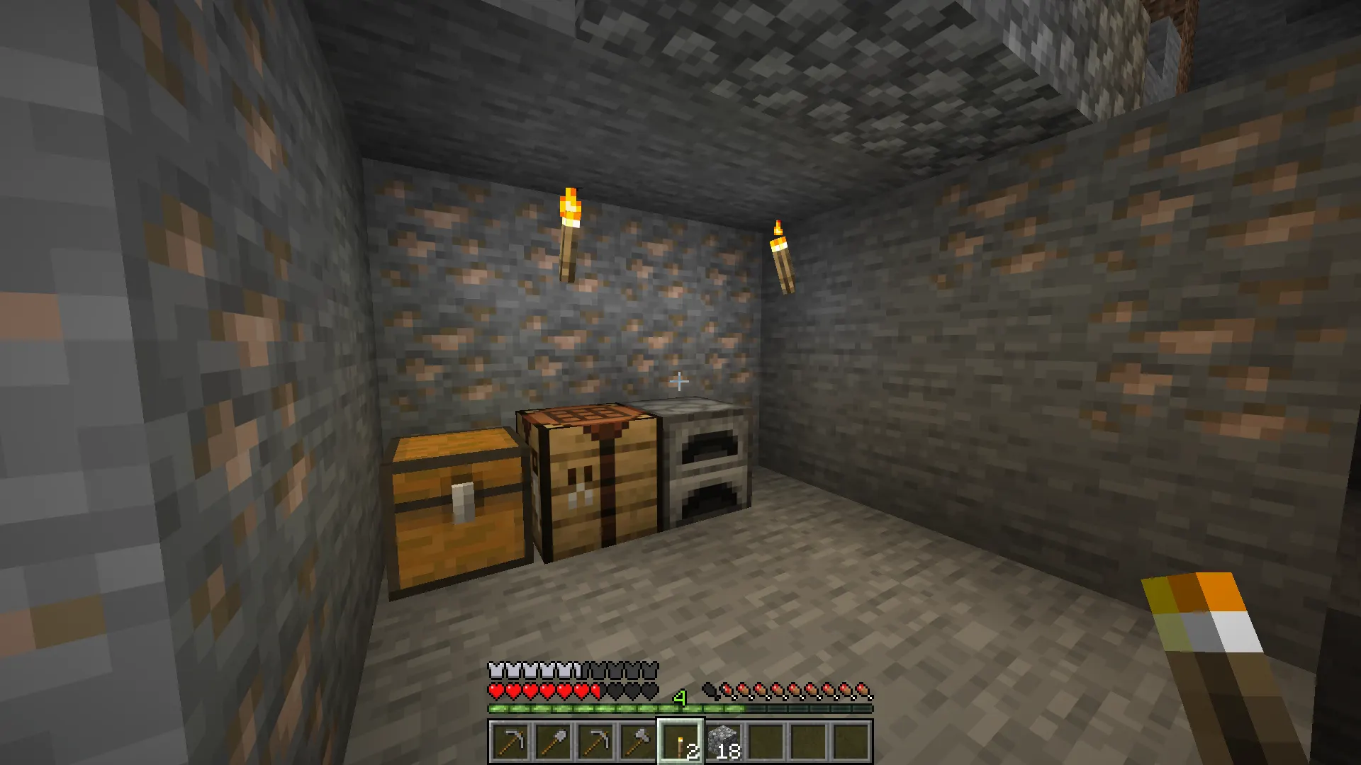 Early game Minecraft cave setup with a stone tools furnace, and torches
