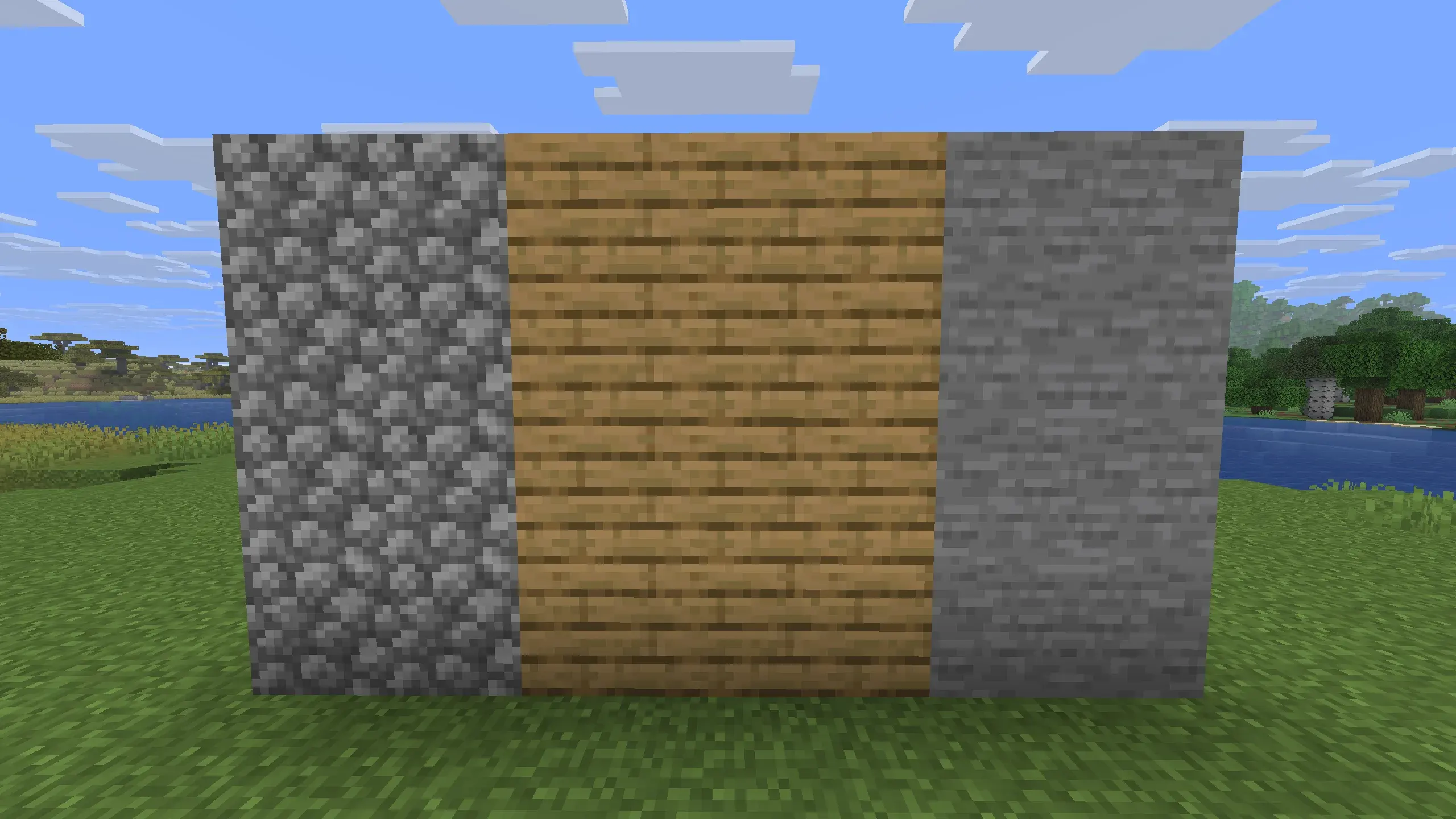 Close-up of a Minecraft wall under construction showing cobblestone on both sides with oak wood planks in the center, built on a grassy riverbank during daytime."