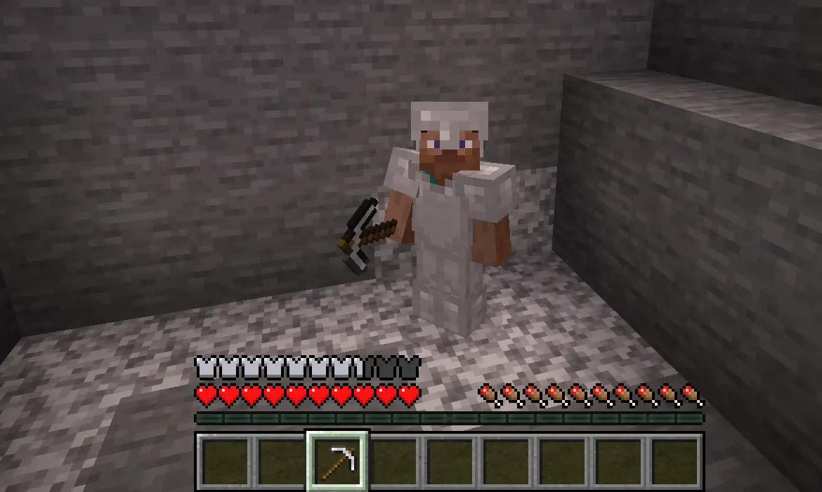 Minecraft player wearing early game iron armor while mining underground